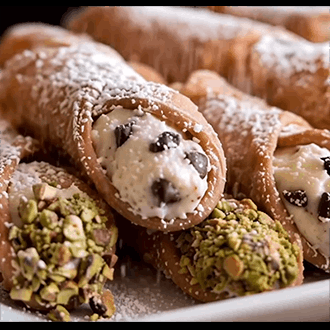 Crispy pastry shells filled with authentic sweet ricotta cream and dusted with powdered sugar