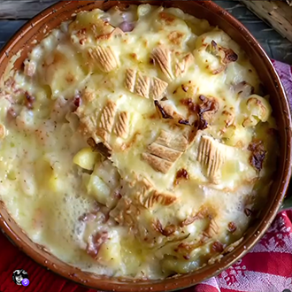Golden brown Tartiflette Savoyarde baked with melted Reblochon cheese, potatoes, and lardons
